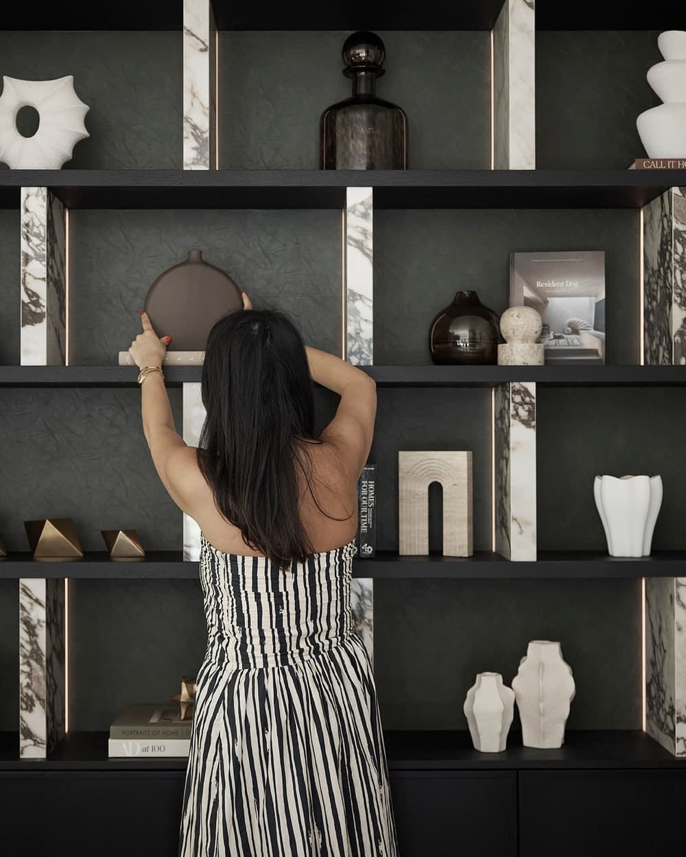 Steph Hakim styling a bespoke shelving display in a Prestbury Road home
