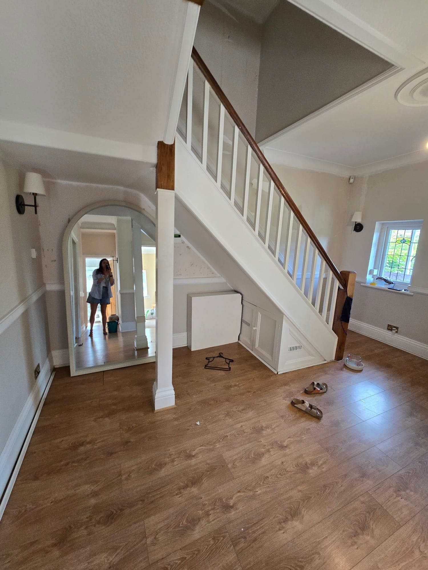 The hallway and staircase before the renovation, with the original timber spindles and flooring
