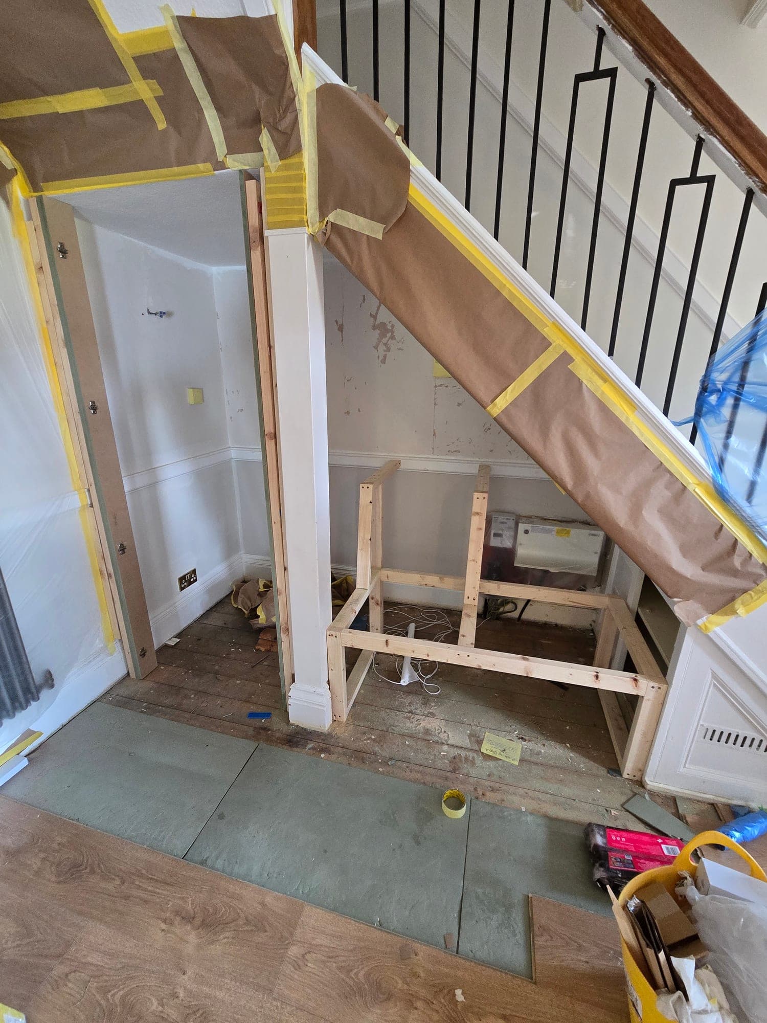 The understairs area being framed out for a bespoke window seat