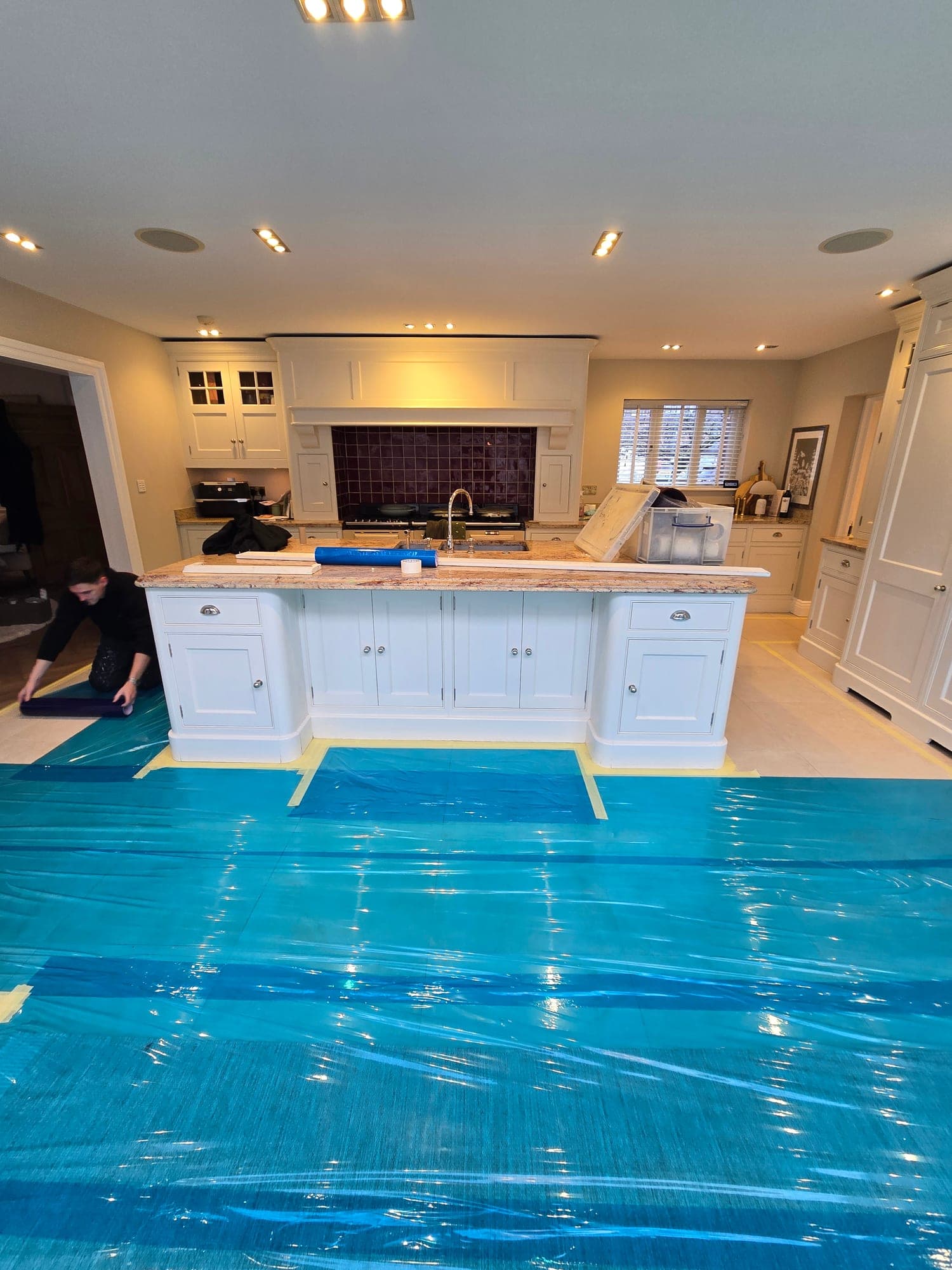 The existing kitchen masked up and the floor fully protected before the hand-painting started