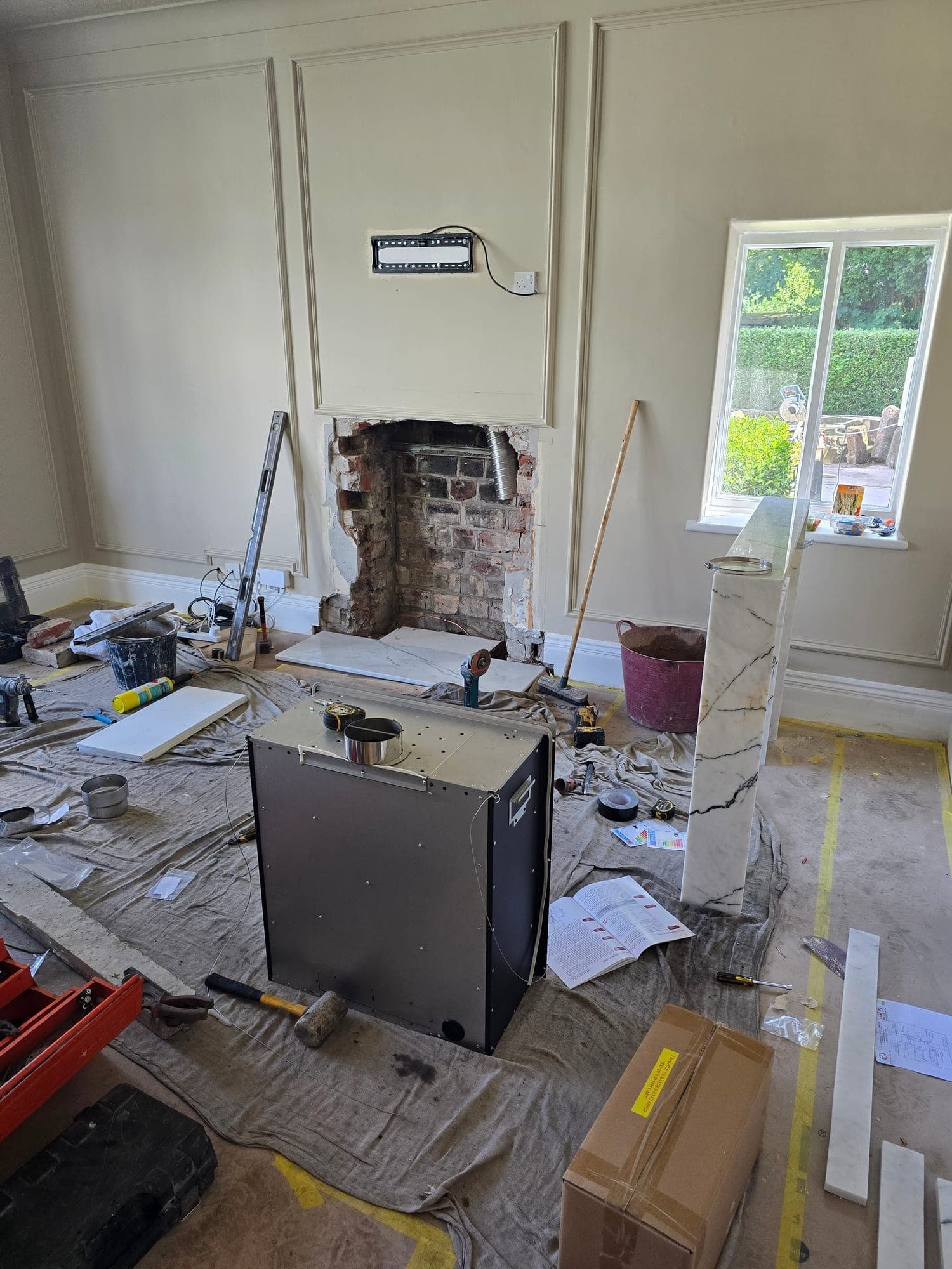 The fireplace opening stripped back to brick, ready for the new surround