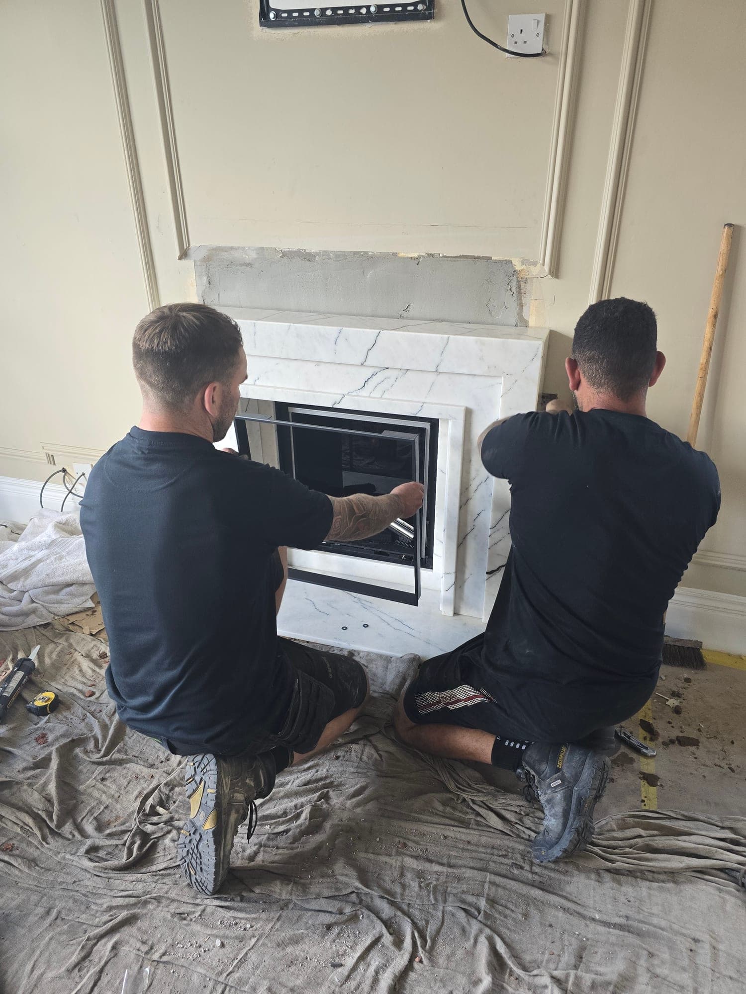 The new fire surround and linear insert being fitted on site