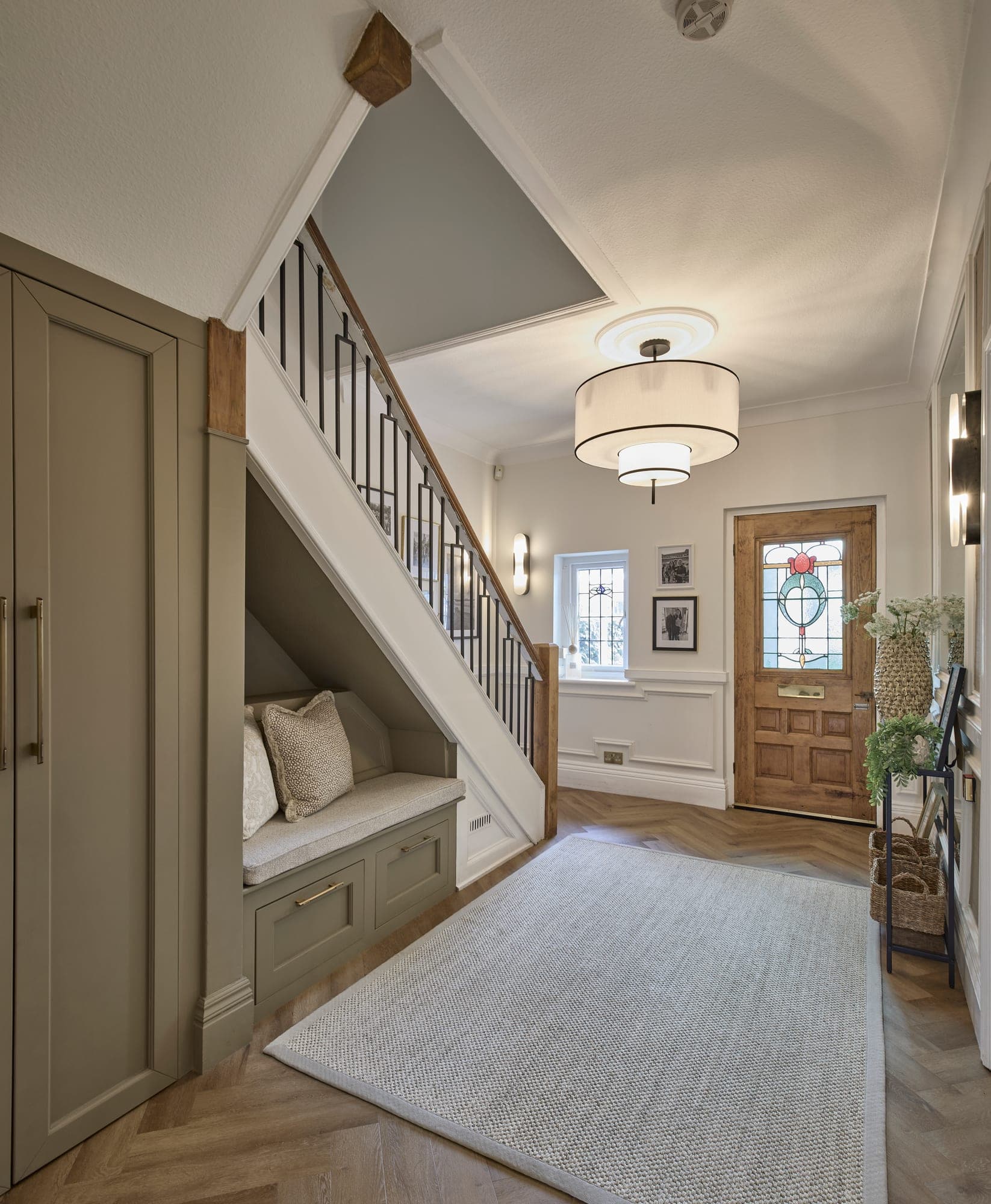 The finished entrance hall in Hale, with panelling, herringbone floor and the new balustrade
