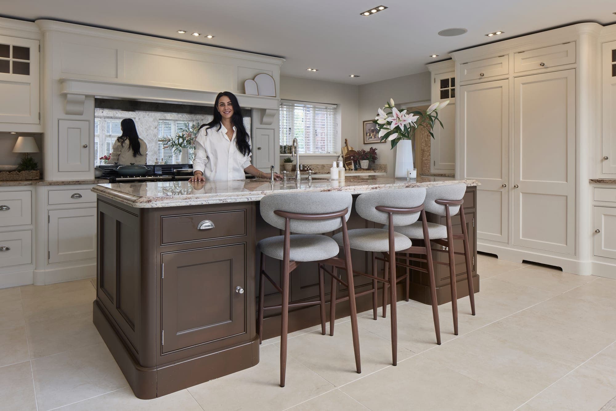 The finished kitchen in a Hale family home, with hand-painted cabinetry, a granite island and an antiqued mirror splashback