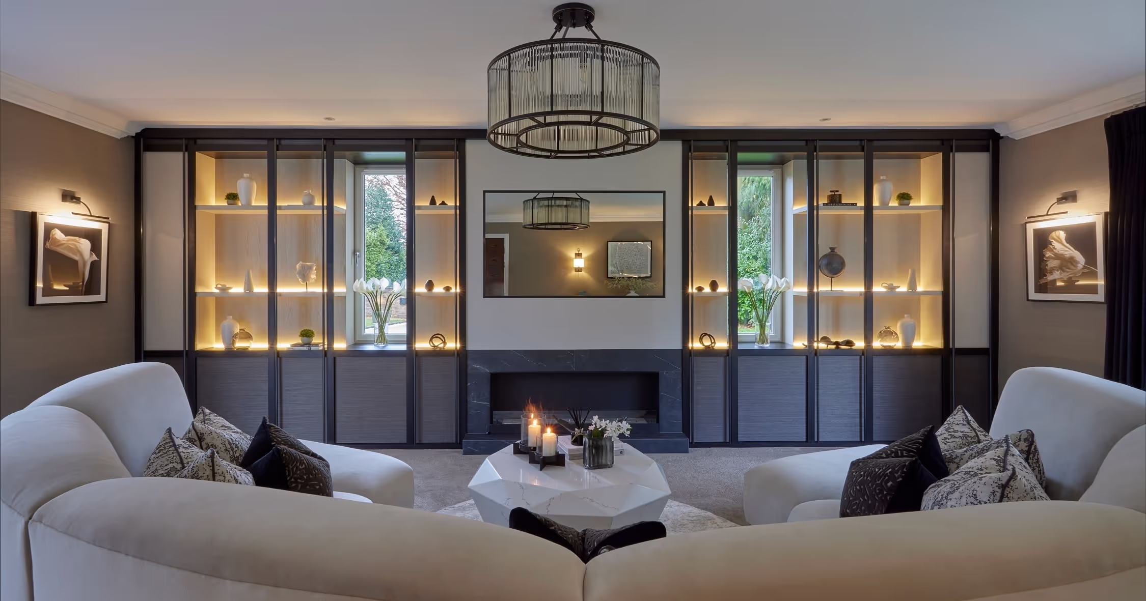 A calm Knutsford living room with backlit display cabinets and curved sofas