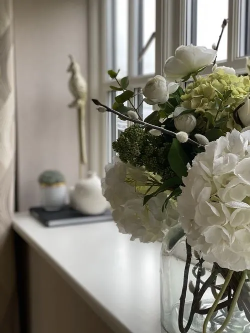 Fresh flowers and a considered vignette bring a surface to life